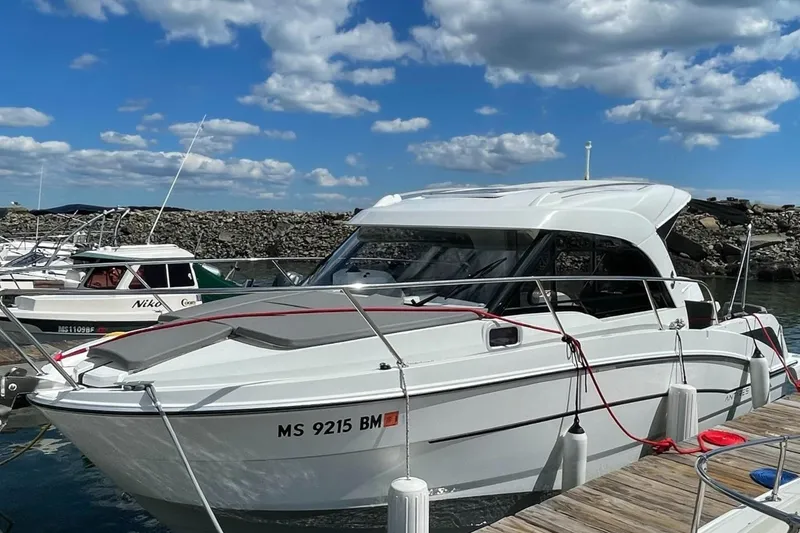 Slide: The Image of 2020 Beneteau Antares 23 docked at marina under blue sky. - 2