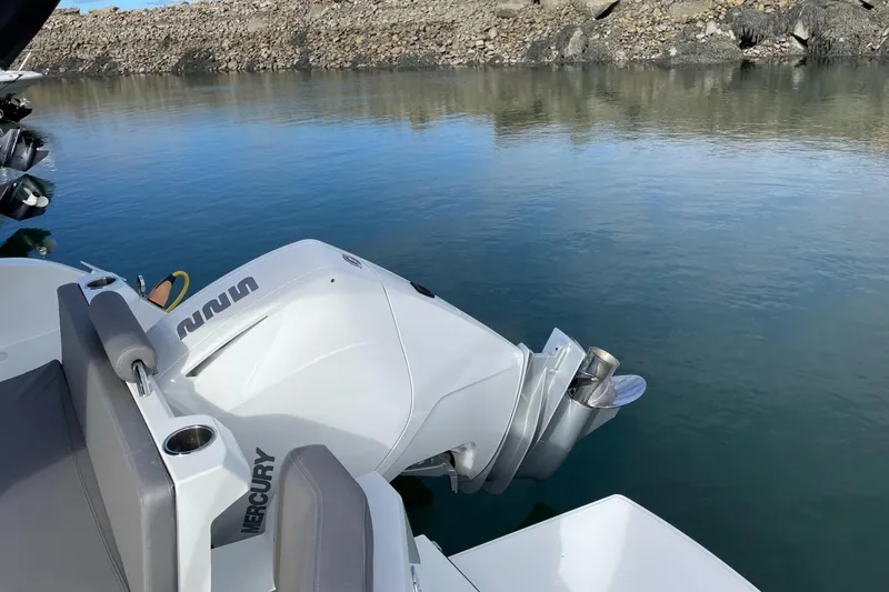 Slide: The Image of 2020 Beneteau Antares 23 with Mercury outboard engine on calm water. - 24