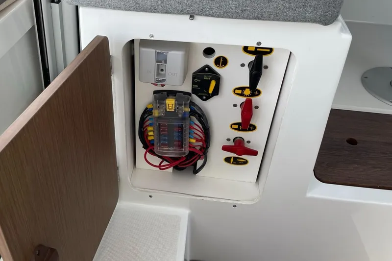 Slide: The Image of Electrical panel inside a 2020 Beneteau Antares 23 boat, featuring switches and wiring. - 29