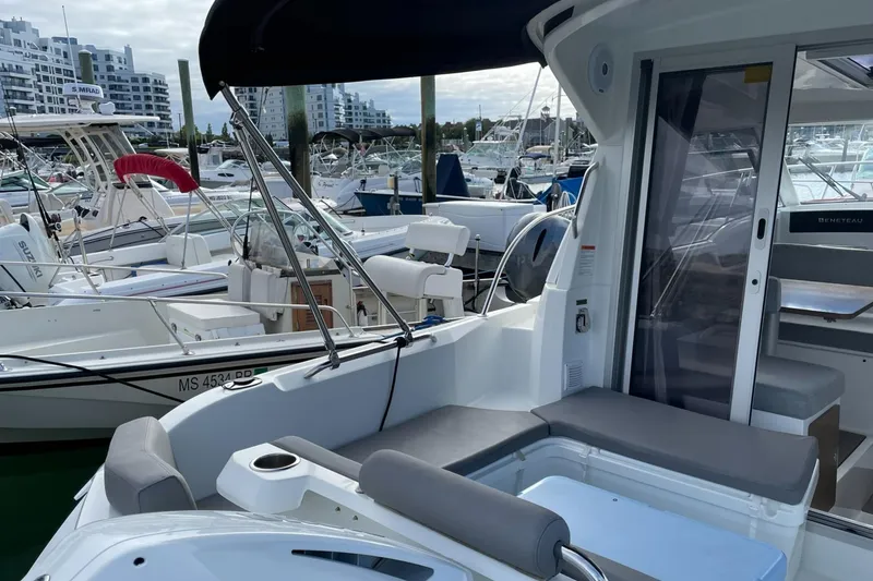 Slide: The Image of Beneteau Antares 23, 2020 model, docked at marina with modern seating and helm. - 3