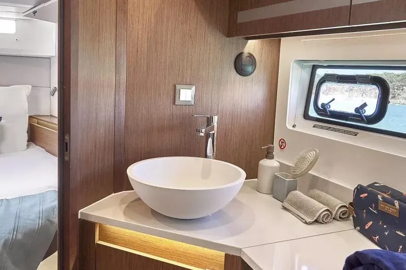 Slide: The Image of Luxurious bathroom interior of 2026 Beneteau Antares 12 yacht with modern sink and window view. - 5