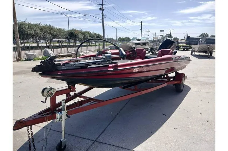 Slide: The Image of 2001 Triton TR19 bass boat on trailer, parked outdoors under clear sky. - 3
