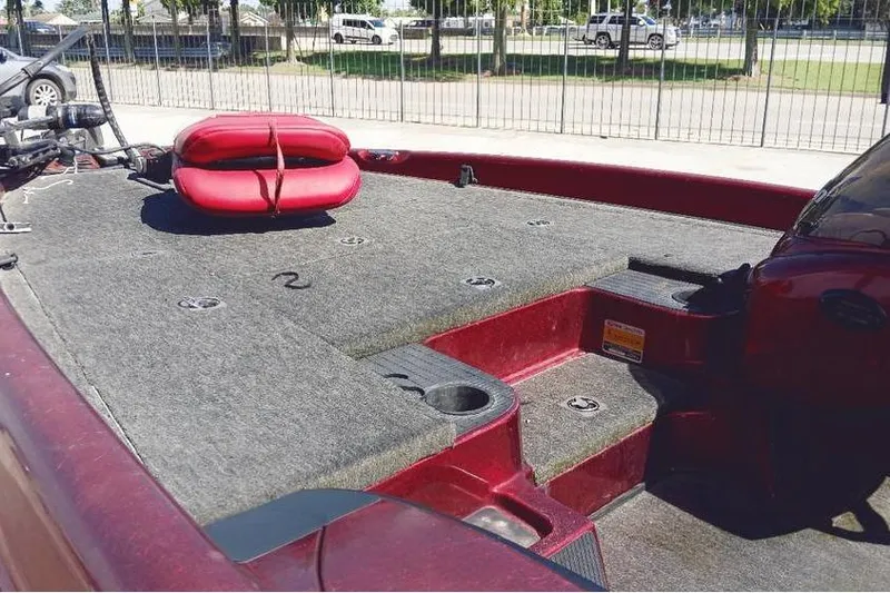 Slide: The Image of 2001 Triton TR19 boat interior with red and gray deck, featuring a red seat cushion. - 7