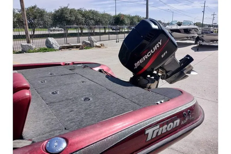 Slide: The Image of 2001 Triton TR19 boat with Mercury EFI engine, parked outdoors. - 9