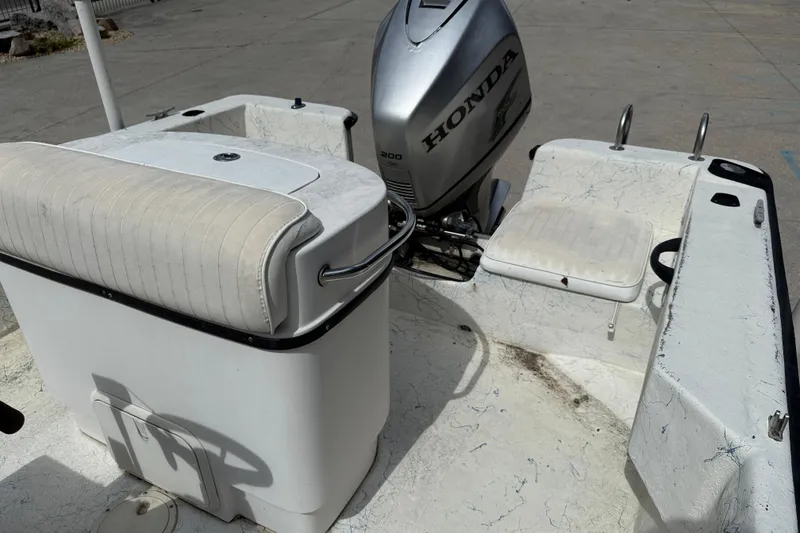 Slide: The Image of 1998 Hydra-Sports 22 Ocean CC boat interior with seating and motor, showing wear and dirt. - 13