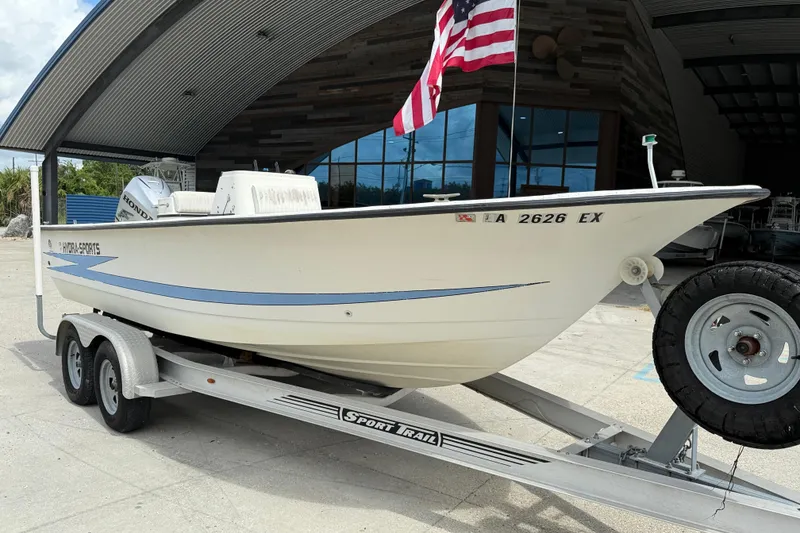 Slide: The Image of 1998 Hydra-Sports 22 Ocean CC boat on trailer, parked outdoors under cloudy sky. - 2