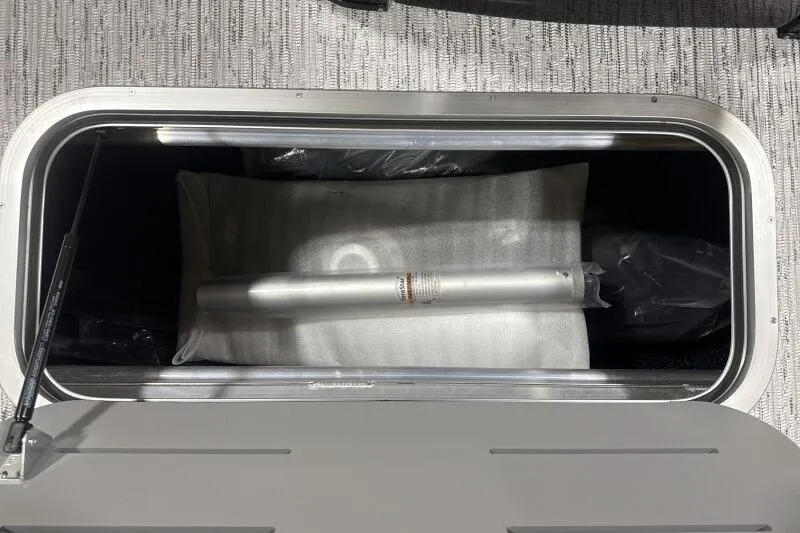 Slide: The Image of Storage compartment in 2026 Bennington 24 MFBSF boat, featuring a metal rod and cushion. - 15