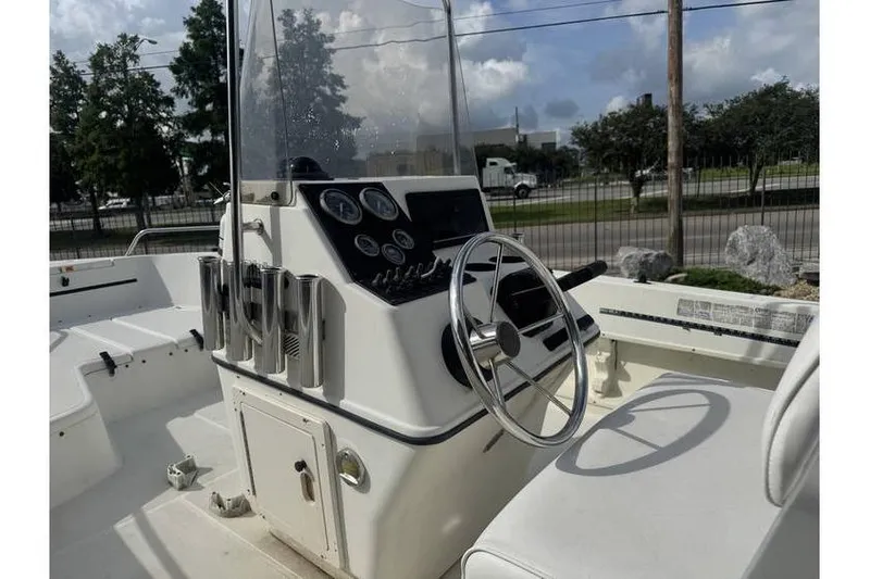 Slide: The Image of 2000 Hydra-Sports 18cc boat interior with console and seating, docked outdoors. - 10