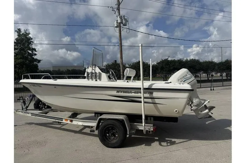 Slide: The Image of 2000 Hydra-Sports 18cc boat on trailer, parked outdoors under cloudy sky. - 3