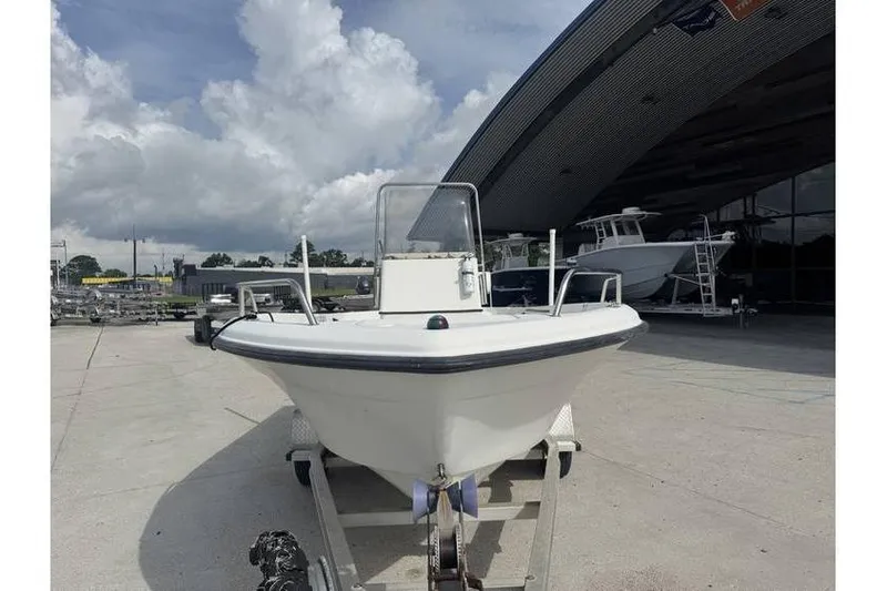 Slide: The Image of 2000 Hydra-Sports 18cc boat with outboard motor, parked outdoors on a sunny day. - 5