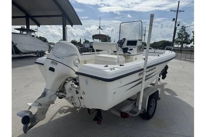 Slide: The Image of 2000 Hydra-Sports 18cc boat on trailer with Evinrude outboard motor, parked outdoors. - 6