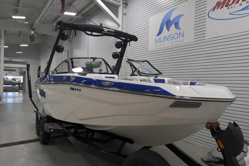 Slide: The Image of 2026 Malibu Wakesetter 22 LSV boat in showroom, featuring sleek design and modern features. - 1