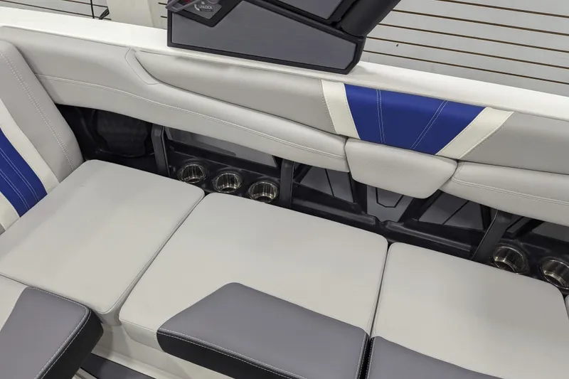 Slide: The Image of 2026 Malibu Wakesetter 22 LSV interior seating with cup holders and blue accents. - 18