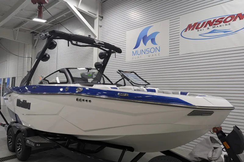Slide: The Image of 2026 Malibu Wakesetter 22 LSV boat in showroom, Munson Surf & Wake signage. - 2