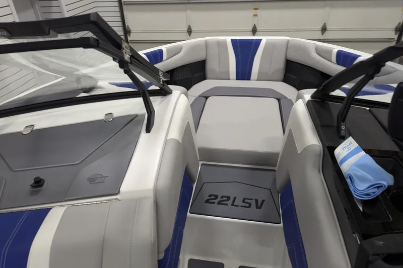 Slide: The Image of 2026 Malibu Wakesetter 22 LSV interior with blue and gray seating, windshield, and logo. - 8