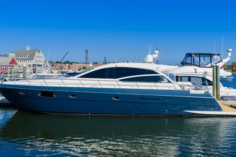Slide: The Image of Luxury 2011 Uniesse 55S yacht docked at a marina under clear blue skies. - 1