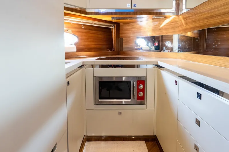 Slide: The Image of Modern kitchen interior on 2011 Uniesse 55S yacht with wood accents and built-in appliances. - 28