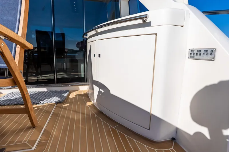 Slide: The Image of Luxury yacht Uniesse 55S 2011 deck with wooden chair and sleek cabinetry. - 12