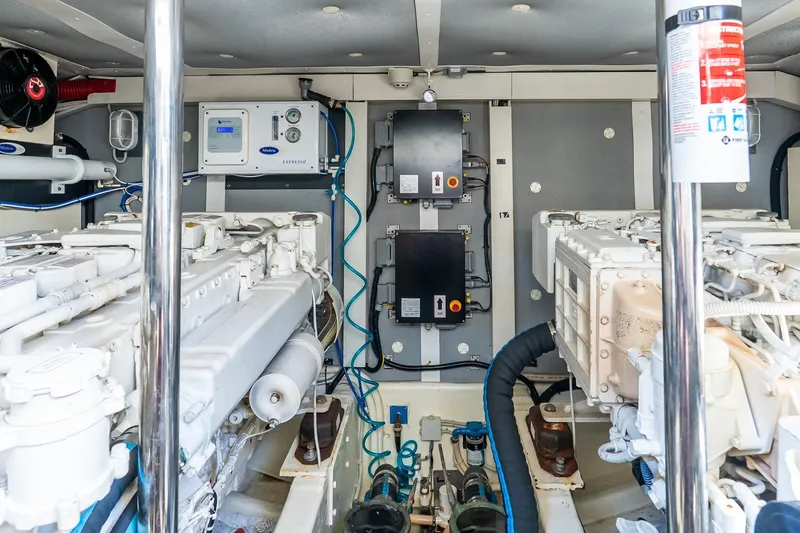 Slide: The Image of Engine room of 2011 Uniesse 55S yacht, showcasing dual engines and control systems. - 37