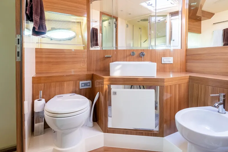 Slide: The Image of Luxurious bathroom in 2011 Uniesse 55S yacht with modern fixtures and wood paneling. - 31