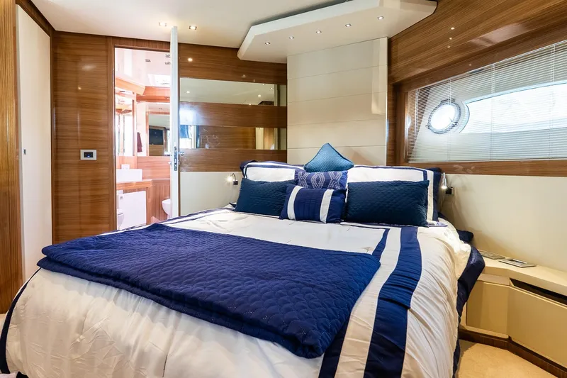 Slide: The Image of Luxurious bedroom interior of 2011 Uniesse 55S yacht with elegant blue and white bedding. - 29