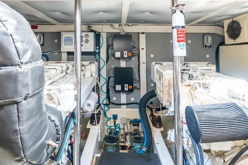 Slide: The Image of Engine room of 2011 Uniesse 55S yacht with visible machinery and fire extinguisher. - 36