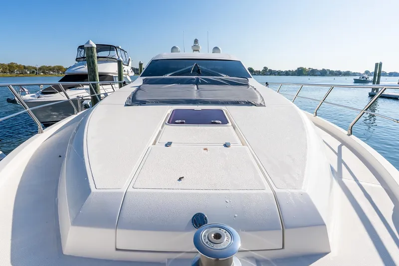 Slide: The Image of 2011 Uniesse 55S yacht docked, showcasing sleek design and spacious deck. - 41