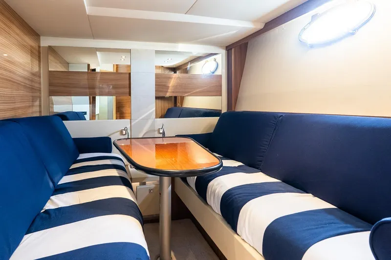 Slide: The Image of Luxurious interior of 2011 Uniesse 55S yacht with striped seating and wooden table. - 27