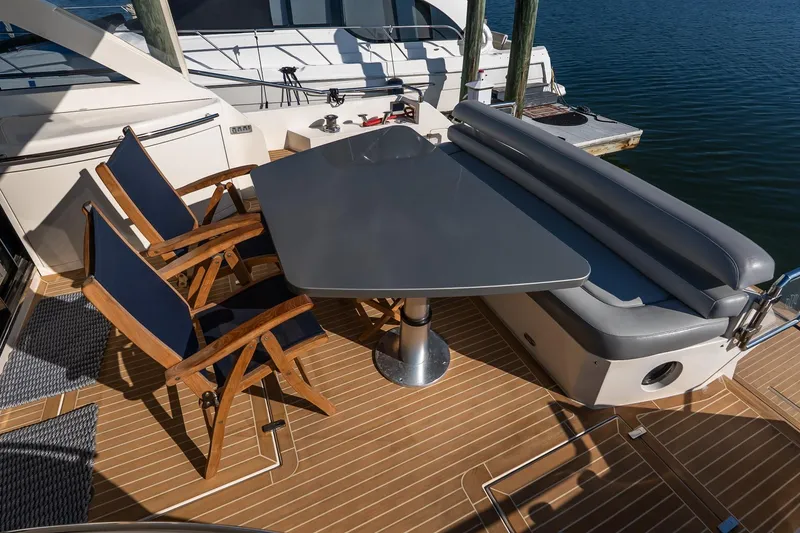 Slide: The Image of Outdoor seating area on 2011 Uniesse 55S yacht with table and chairs. - 8
