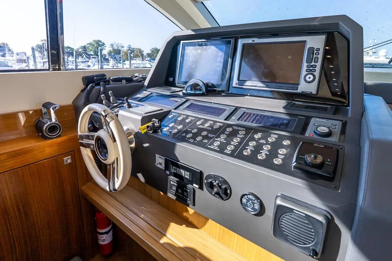 Slide: The Image of Cockpit of 2011 Uniesse 55S yacht with advanced navigation controls and dual screens. - 24