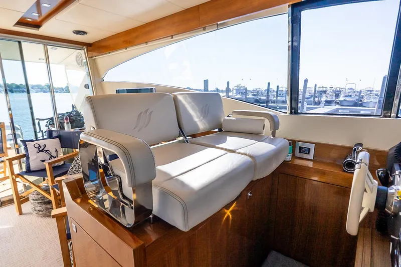 Slide: The Image of Luxurious interior of 2011 Uniesse 55S yacht with plush seating and scenic marina view. - 22
