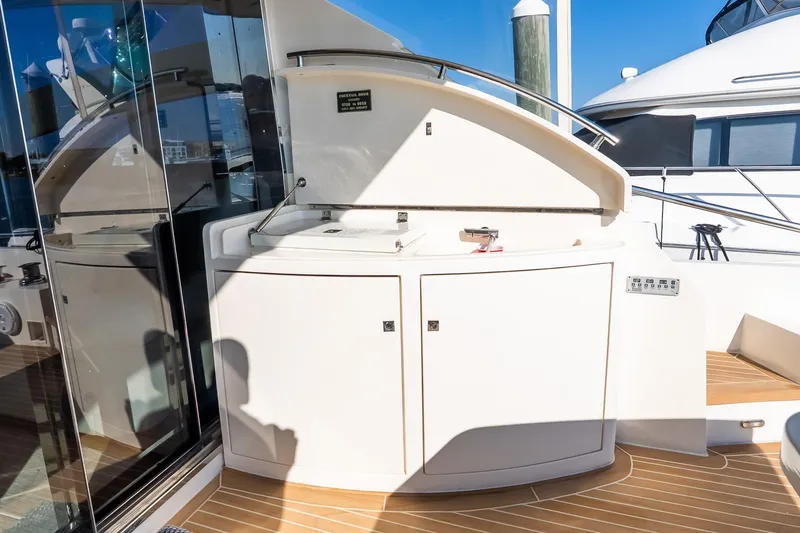 Slide: The Image of Luxury yacht Uniesse 55S 2011, featuring sleek outdoor cabinetry and modern design elements. - 13