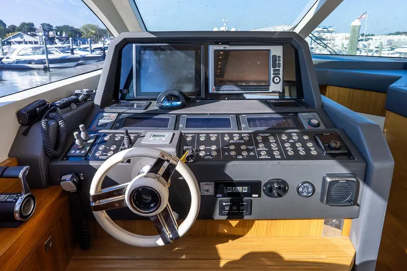 Slide: The Image of Cockpit of 2011 Uniesse 55S yacht with advanced navigation controls and steering wheel. - 25