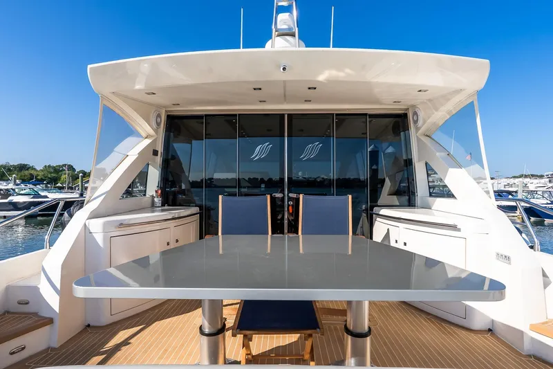 Slide: The Image of Luxury 2011 Uniesse 55S yacht with sleek outdoor dining area and marina view. - 7