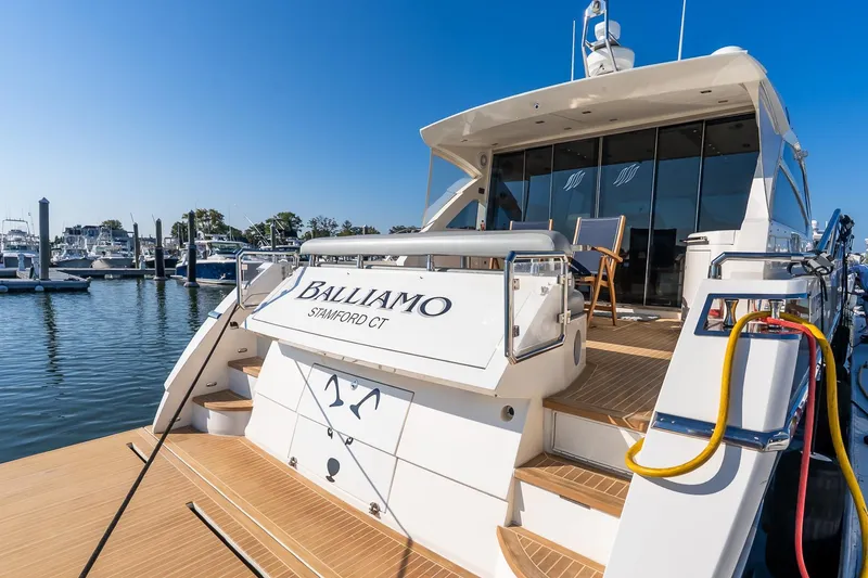 Slide: The Image of Luxury 2011 Uniesse 55S yacht docked at marina under clear blue sky. - 4