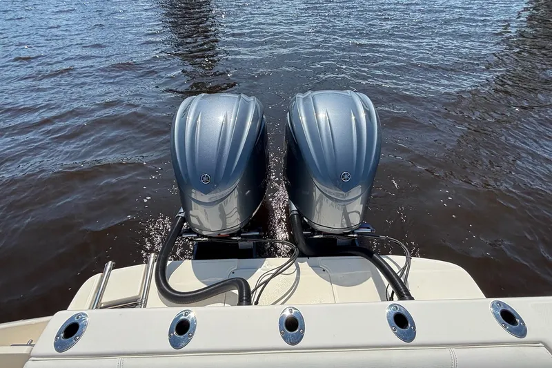 Slide: The Image of 2023 Sea Born LX26 Center Console with twin outboard motors on water. - 11