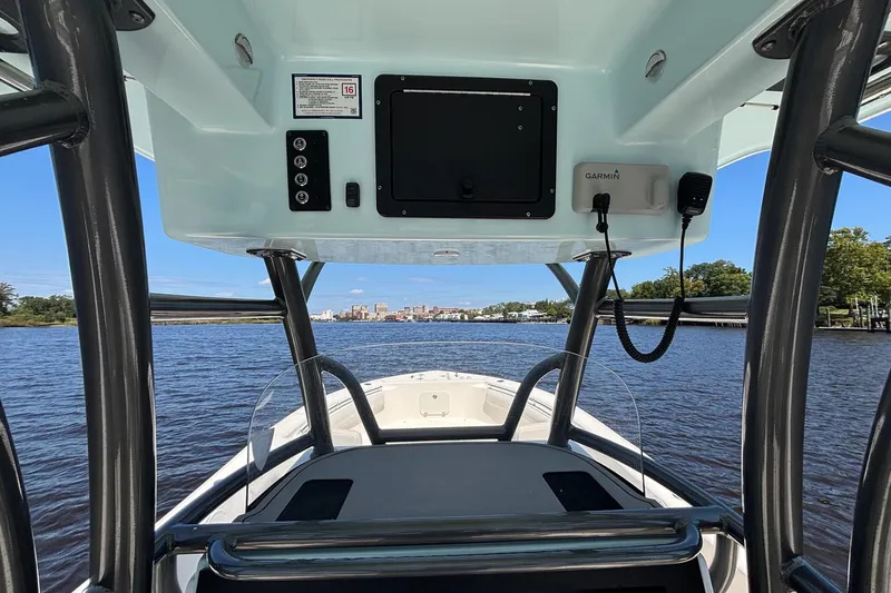 Slide: The Image of 2023 Sea Born LX26 Center Console boat on a scenic river with city skyline. - 16