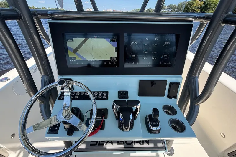 Slide: The Image of 2023 Sea Born LX26 Center Console dashboard with dual screens and steering wheel. - 17