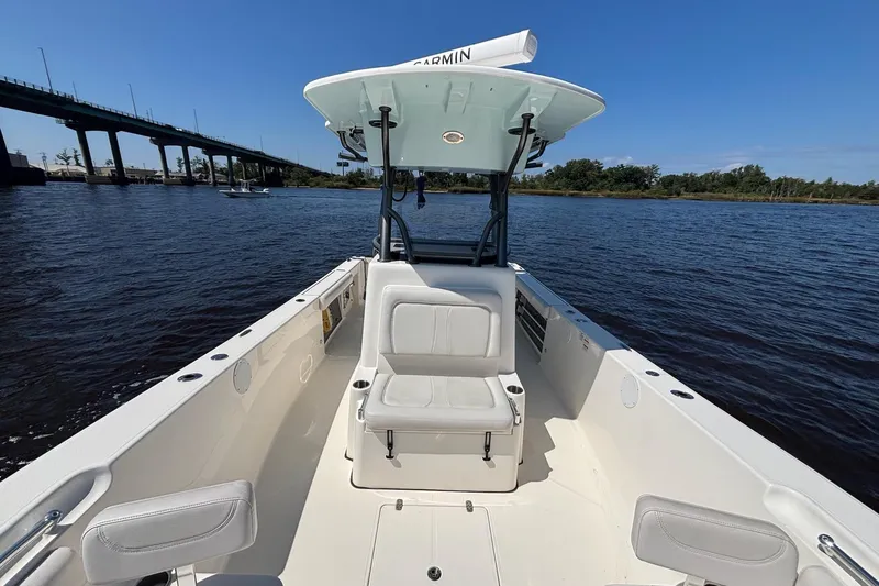Slide: The Image of 2023 Sea Born LX26 Center Console boat on calm water near a bridge. - 20