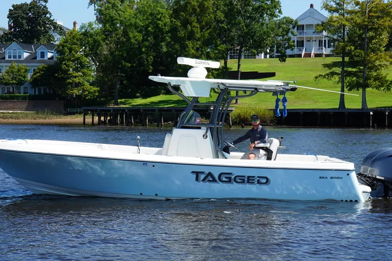 Slide: The Image of 2023 Sea Born LX26 Center Console boat cruising on a scenic waterway. - 3
