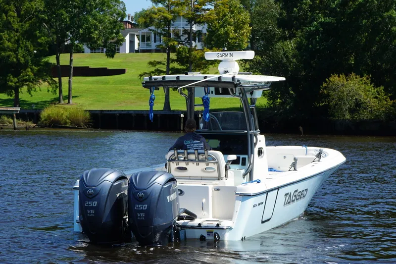 Slide: The Image of 2023 Sea Born LX26 Center Console boat on a scenic river with twin Yamaha engines. - 6