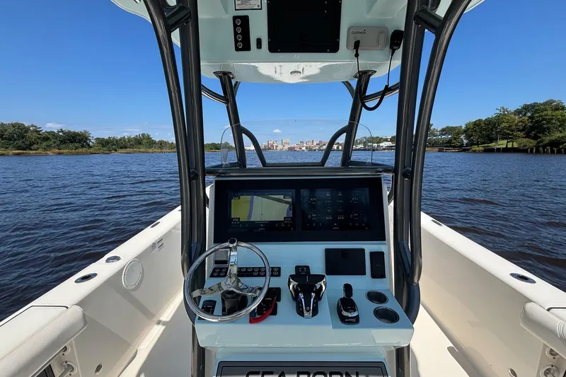 Slide: The Image of 2023 Sea Born LX26 Center Console boat dashboard on a sunny day, river view. - 7