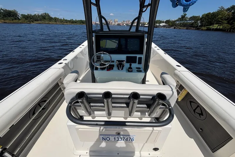 Slide: The Image of 2023 Sea Born LX26 Center Console boat interior with steering and control panel on water. - 8
