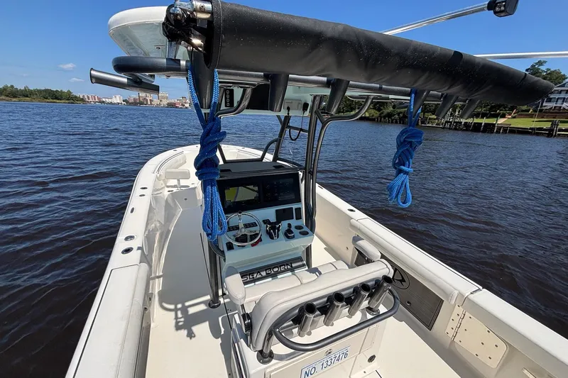 Slide: The Image of 2023 Sea Born LX26 Center Console boat on calm water, featuring modern navigation equipment. - 9