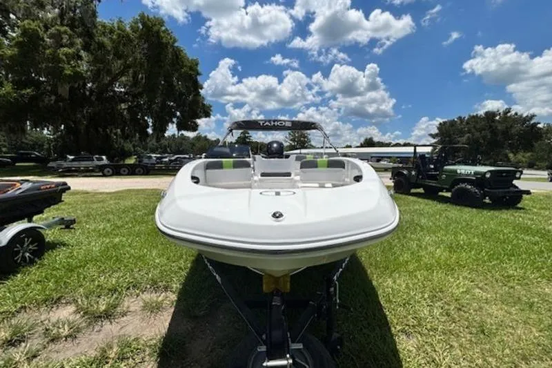 Slide: The Image of 2023 Tahoe T16 boat on grass under a blue sky with clouds. - 2