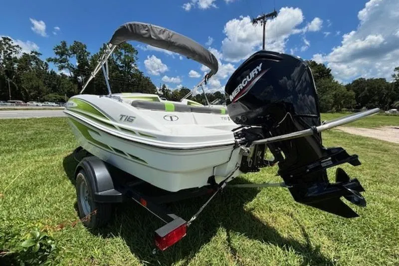 Slide: The Image of 2023 Tahoe T16 boat with Mercury engine on trailer, parked on grass under blue sky. - 6