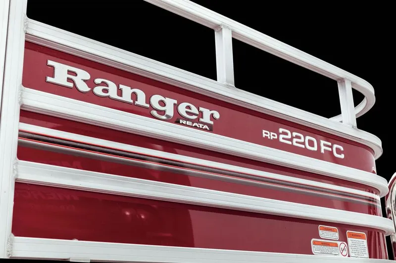 Slide: The Image of 2025 Ranger 220FC boat, red exterior with white railing, close-up view. - 6