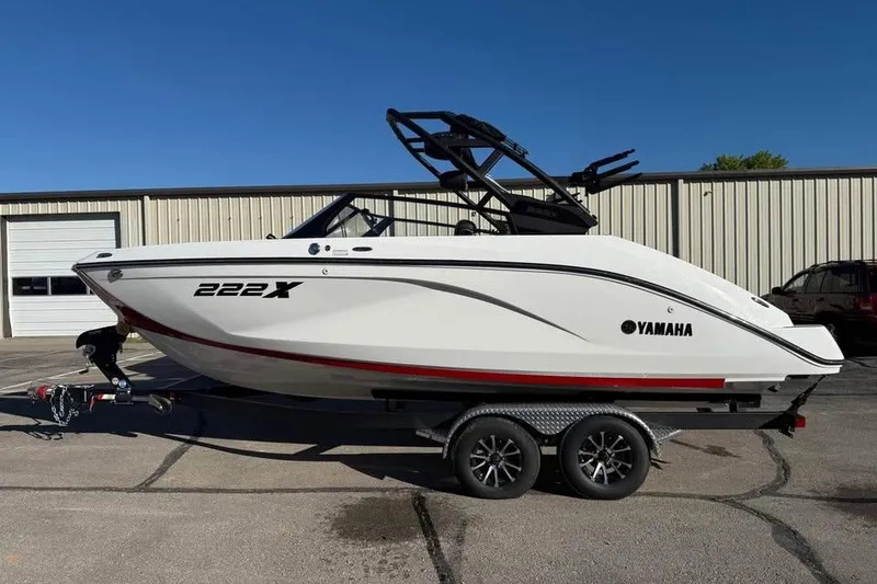 The Image of 2026 Yamaha Boats 222XD on trailer, parked outdoors, side view. - 0