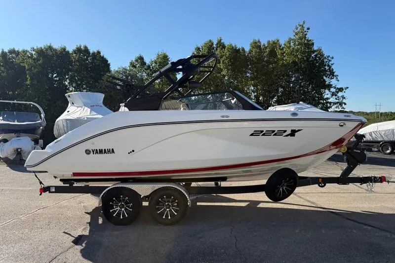 Slide: The Image of 2026 Yamaha Boats 222XD on trailer, parked outdoors with trees in background. - 3