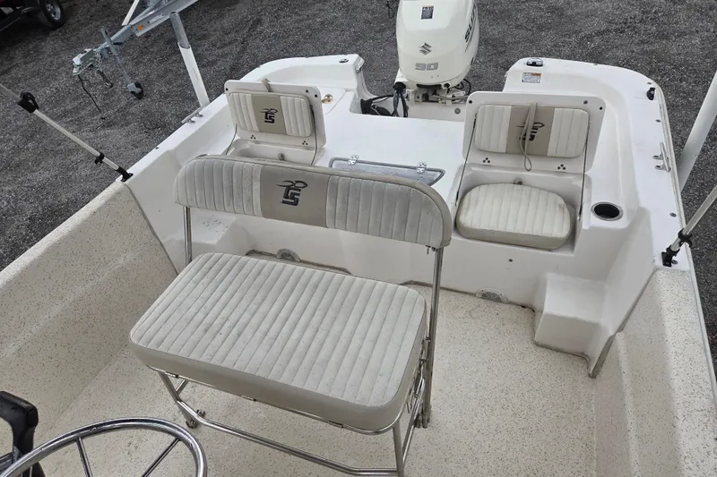 Slide: The Image of 2019 Carolina Skiff 198 DLV boat interior with seating and Suzuki outboard motor. - 10